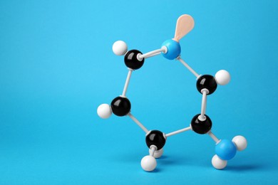 Photo of Structure of molecule on light blue background, space for text. Chemical model