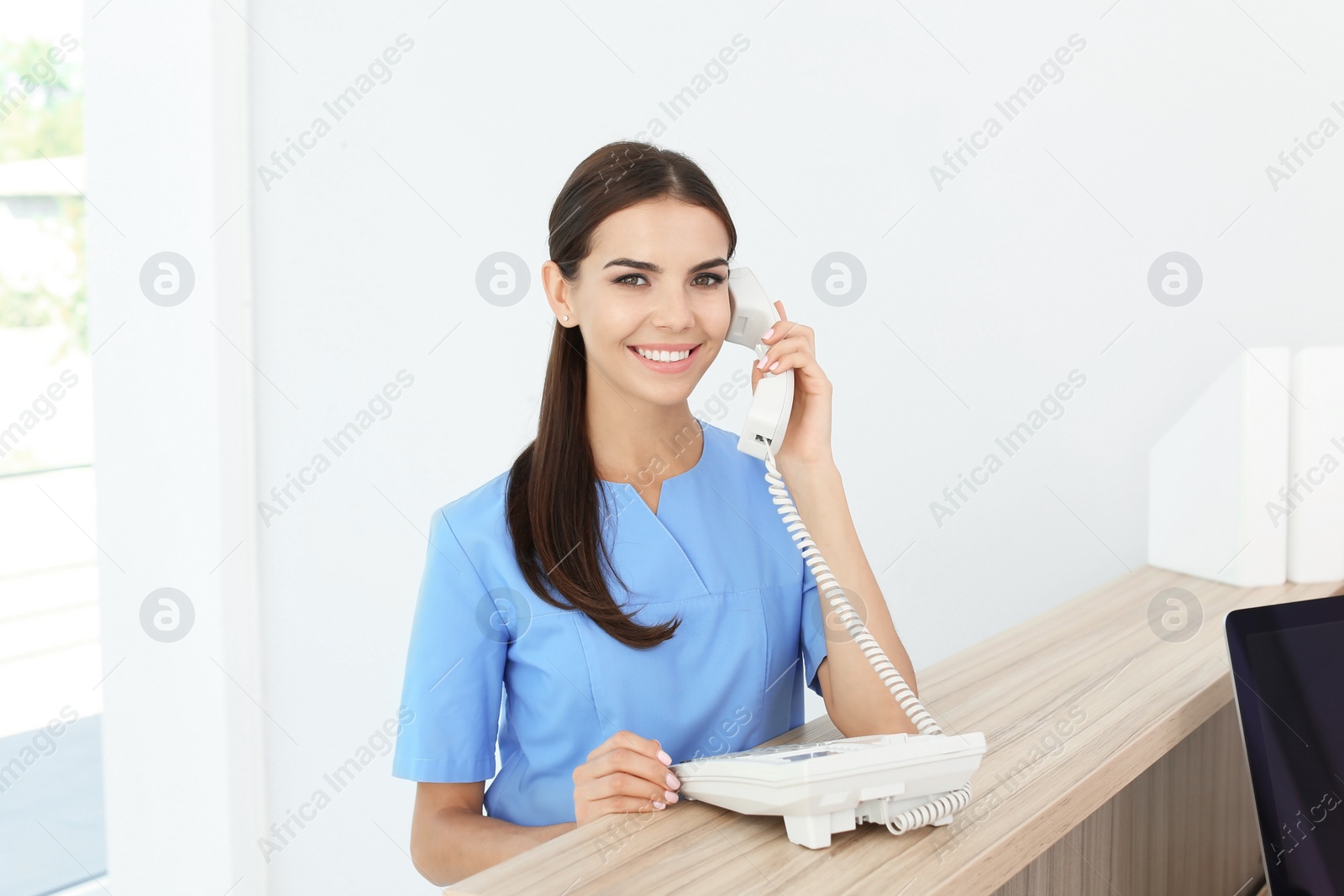 Photo of Female medical assistant at workplace in clinic. Health care service