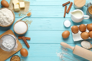 Photo of Flat lay composition with fresh ingredients for delicious homemade cake on blue wooden table. Space for text