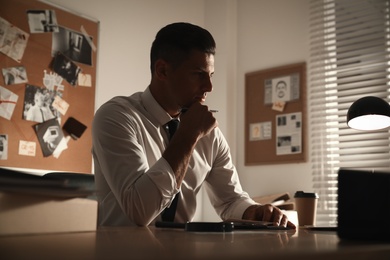 Detective working at desk in his office