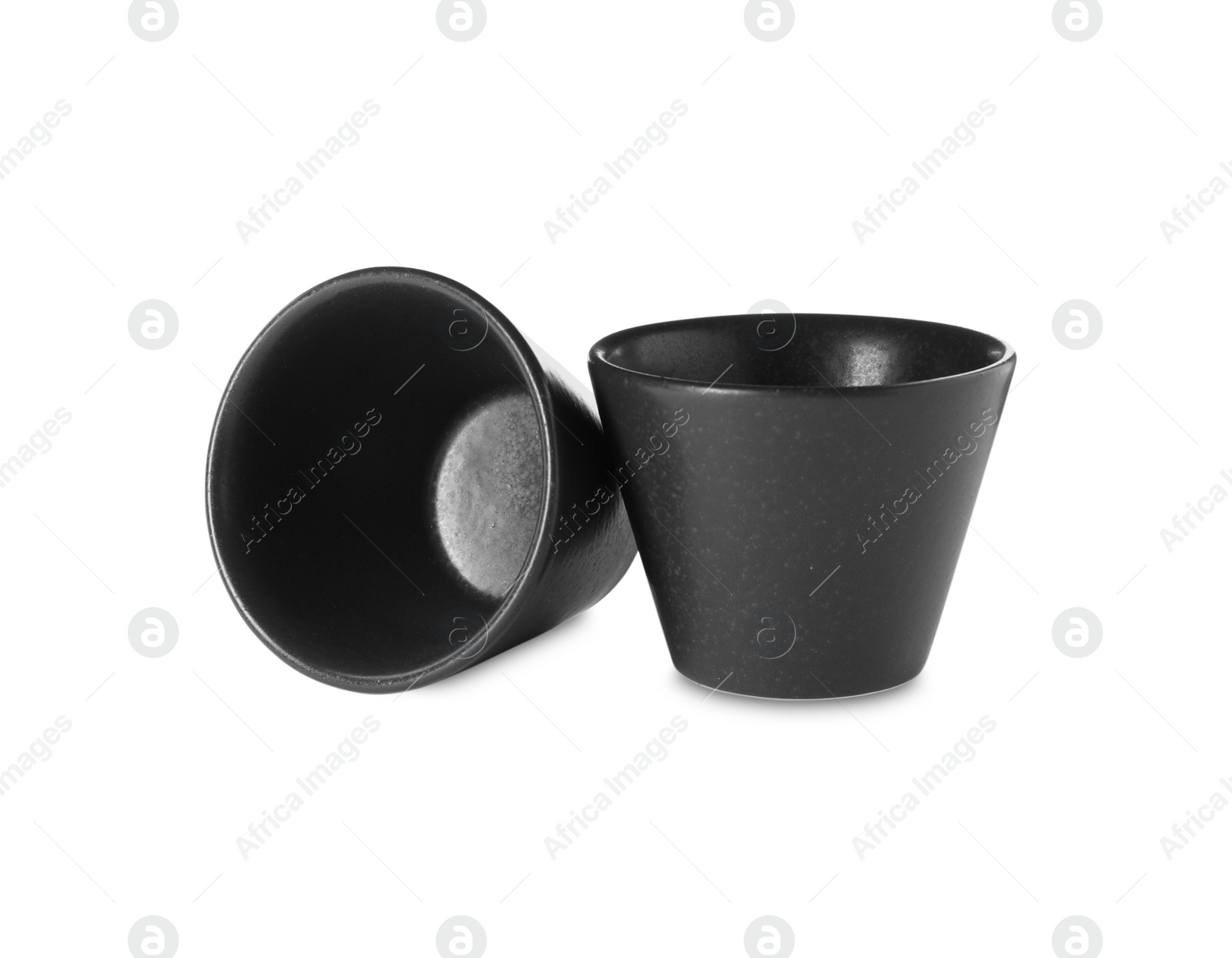 Photo of New black sauce dishes on white background