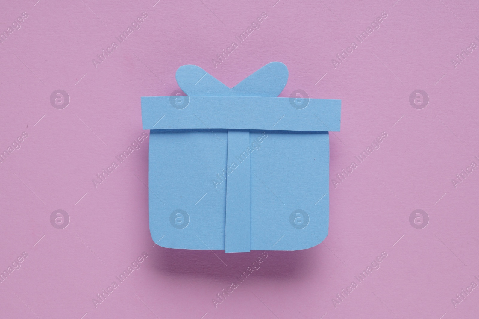 Photo of Paper gift box on pink background, top view