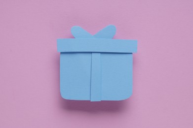 Paper gift box on pink background, top view