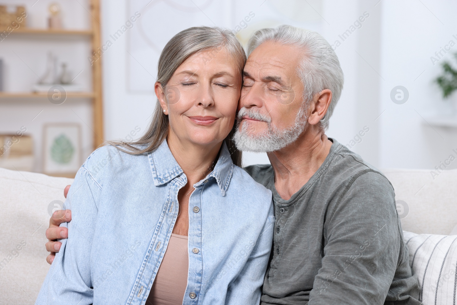 Photo of Portrait of affectionate senior couple at home