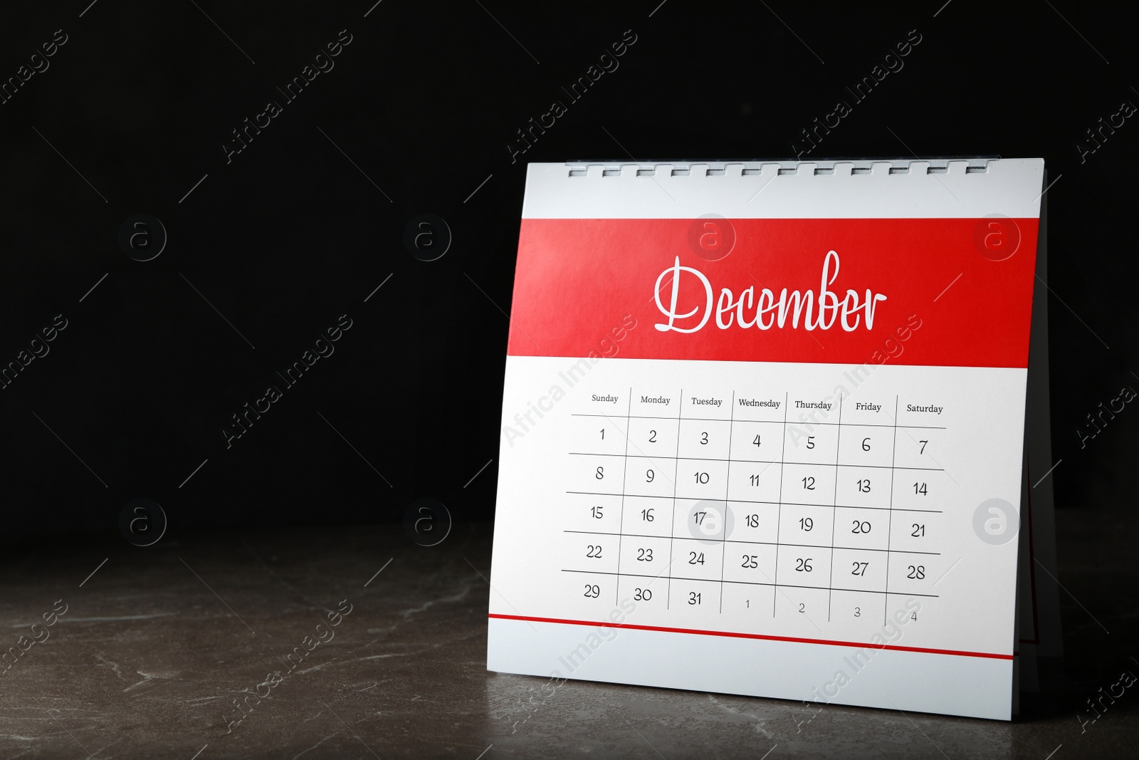 Photo of Paper calendar on stone table, space for text. Planning concept