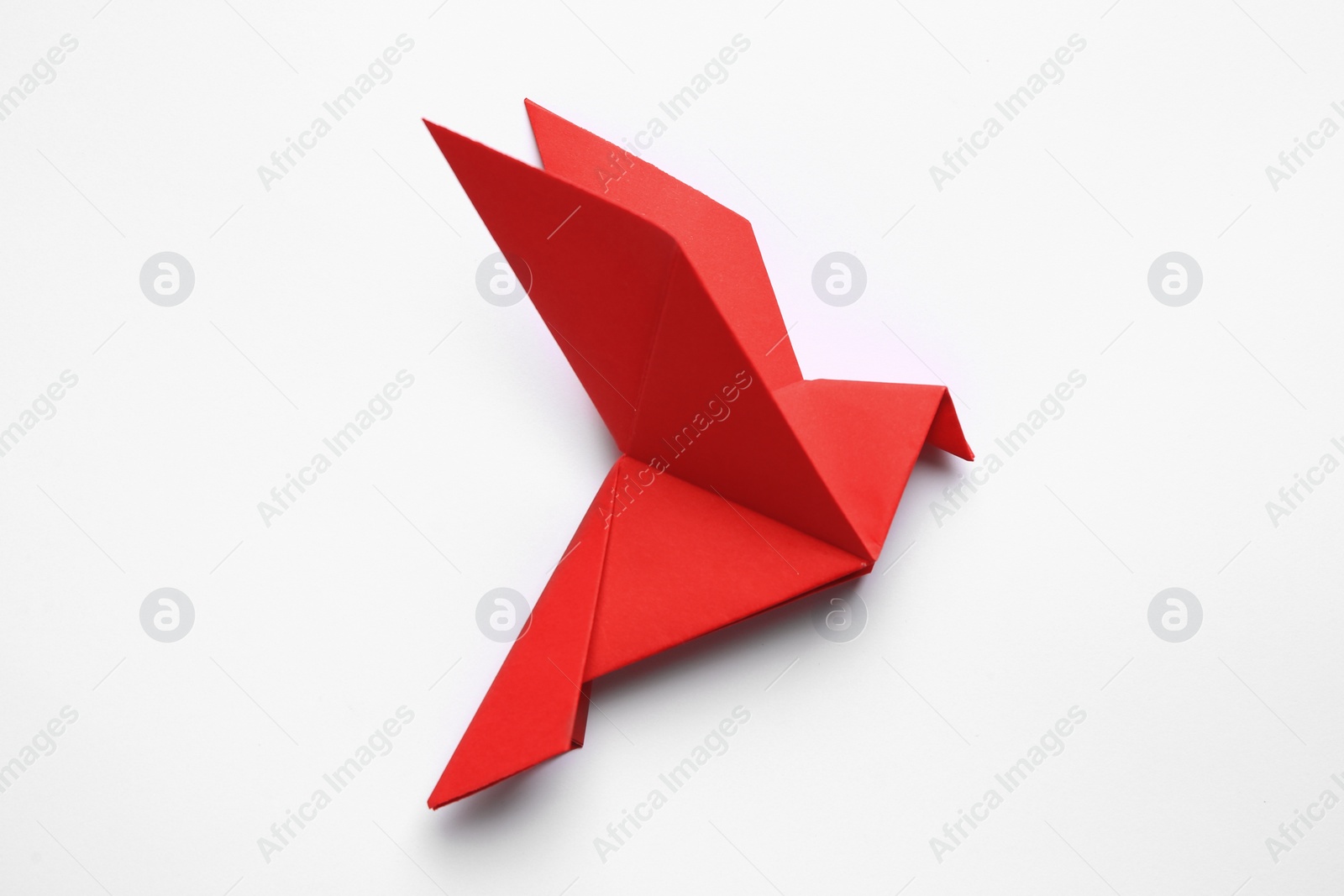 Photo of Beautiful red origami bird on white background, top view