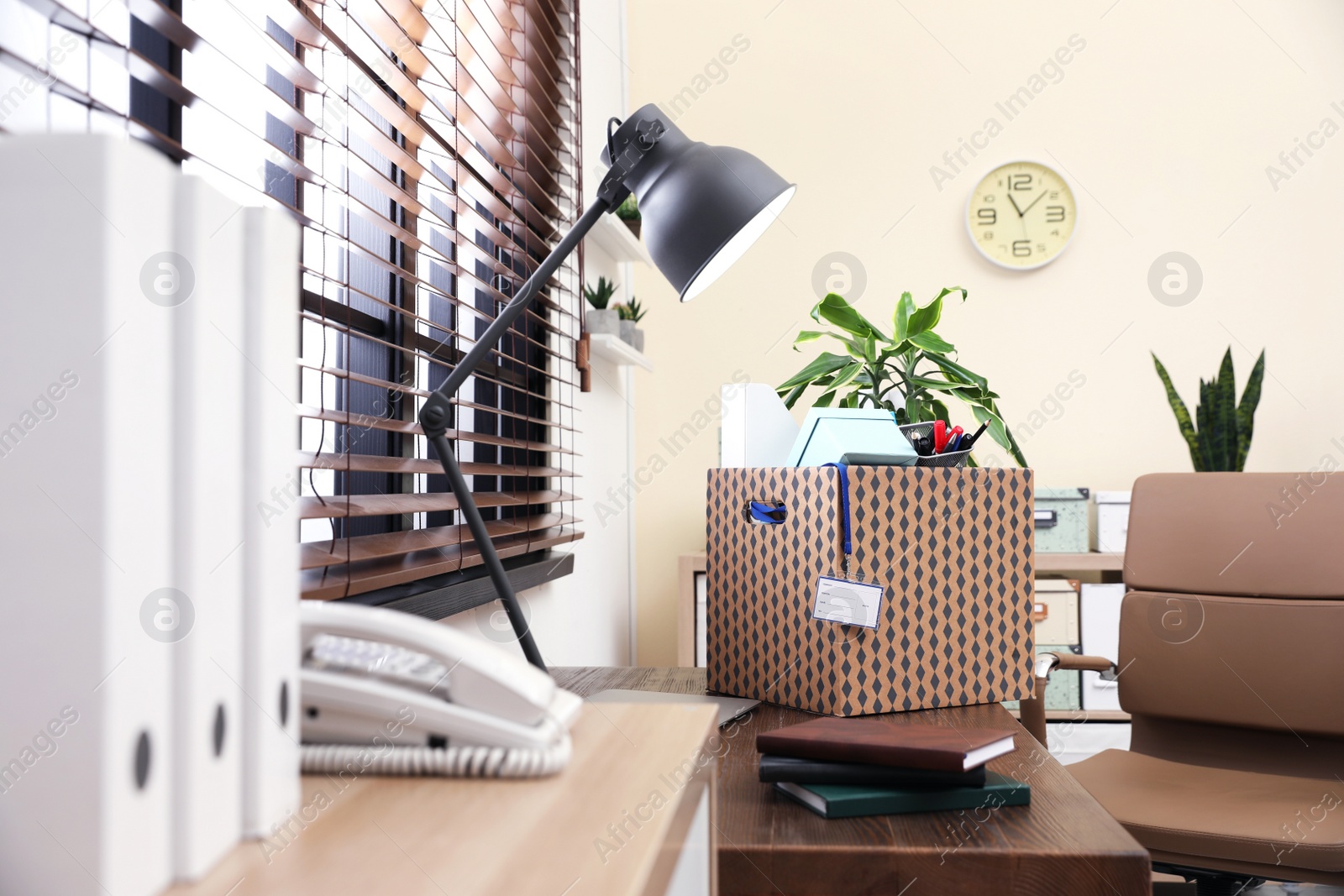 Photo of Moving box on desk in office. Work promotion concept