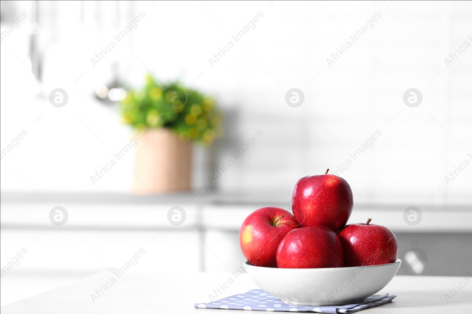 Photo of Bowl of fresh red apples on kitchen counter. Space for text