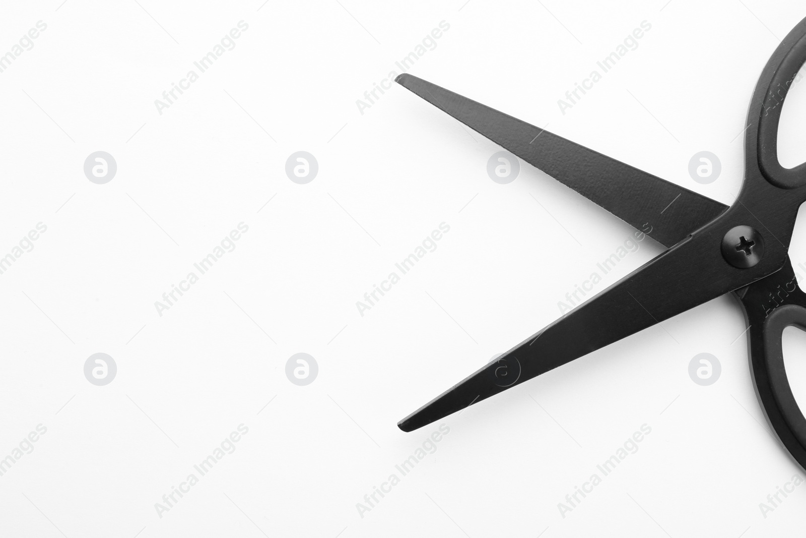 Photo of Pair of sharp scissors on white background