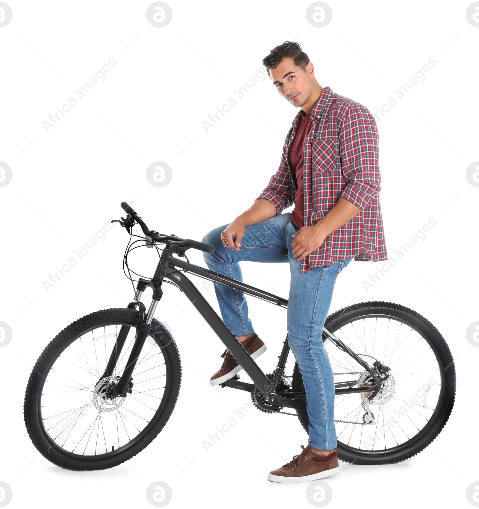 Photo of Handsome young man with modern bicycle on white background