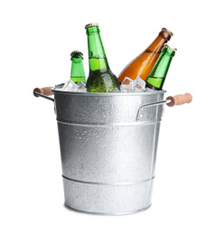 Photo of Metal bucket with bottles of beer and ice cubes isolated on white