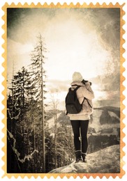 Image of Old paper photo. Young woman with camera on mountain hill