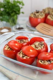 Photo of Delicious stuffed tomatoes with minced beef, bulgur and mushrooms in glass baking dish