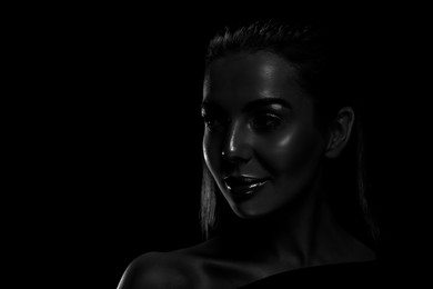 Image of Silhouette of woman in darkness. Portrait on black background