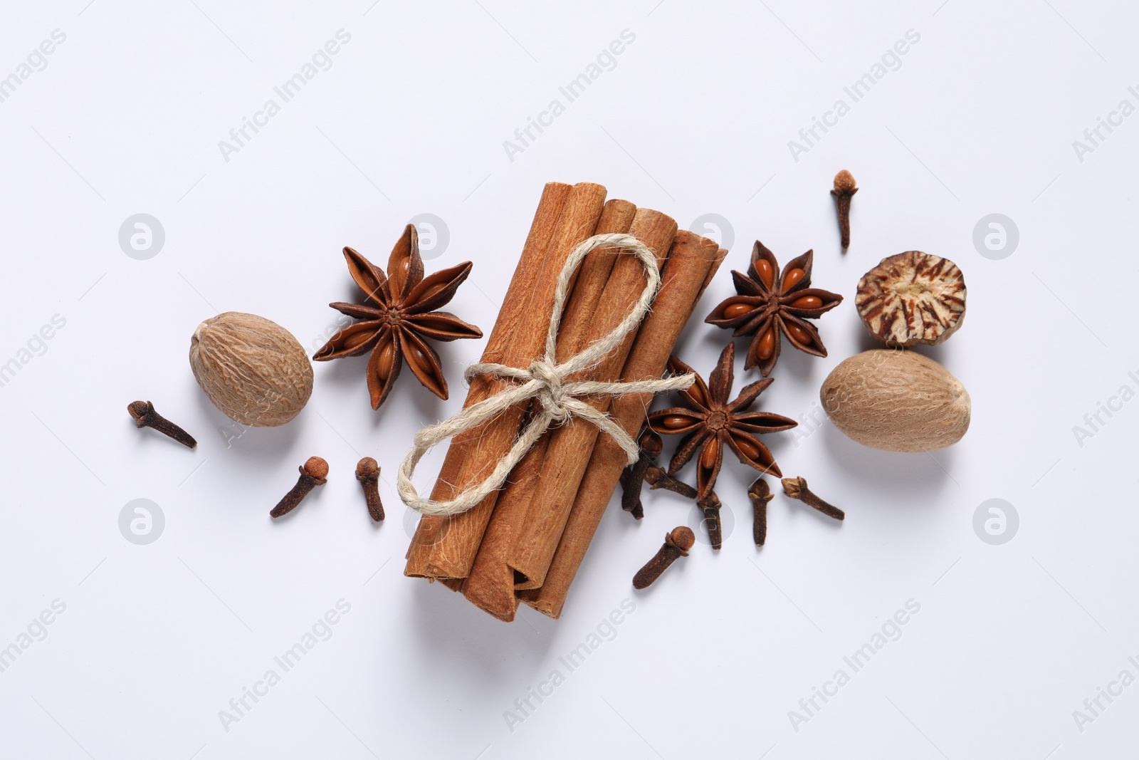 Photo of Different spices and nuts on white background, flat lay