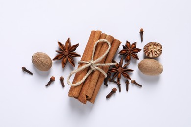 Photo of Different spices and nuts on white background, flat lay