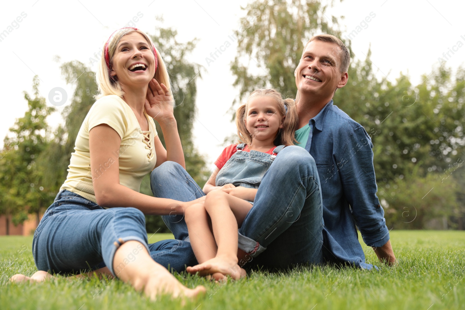 Photo of Happy family spending time together in park on sunny summer day