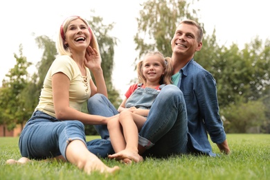 Happy family spending time together in park on sunny summer day