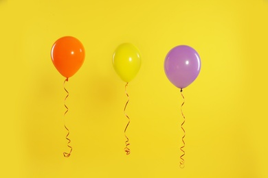 Bright balloons on color background. Celebration time