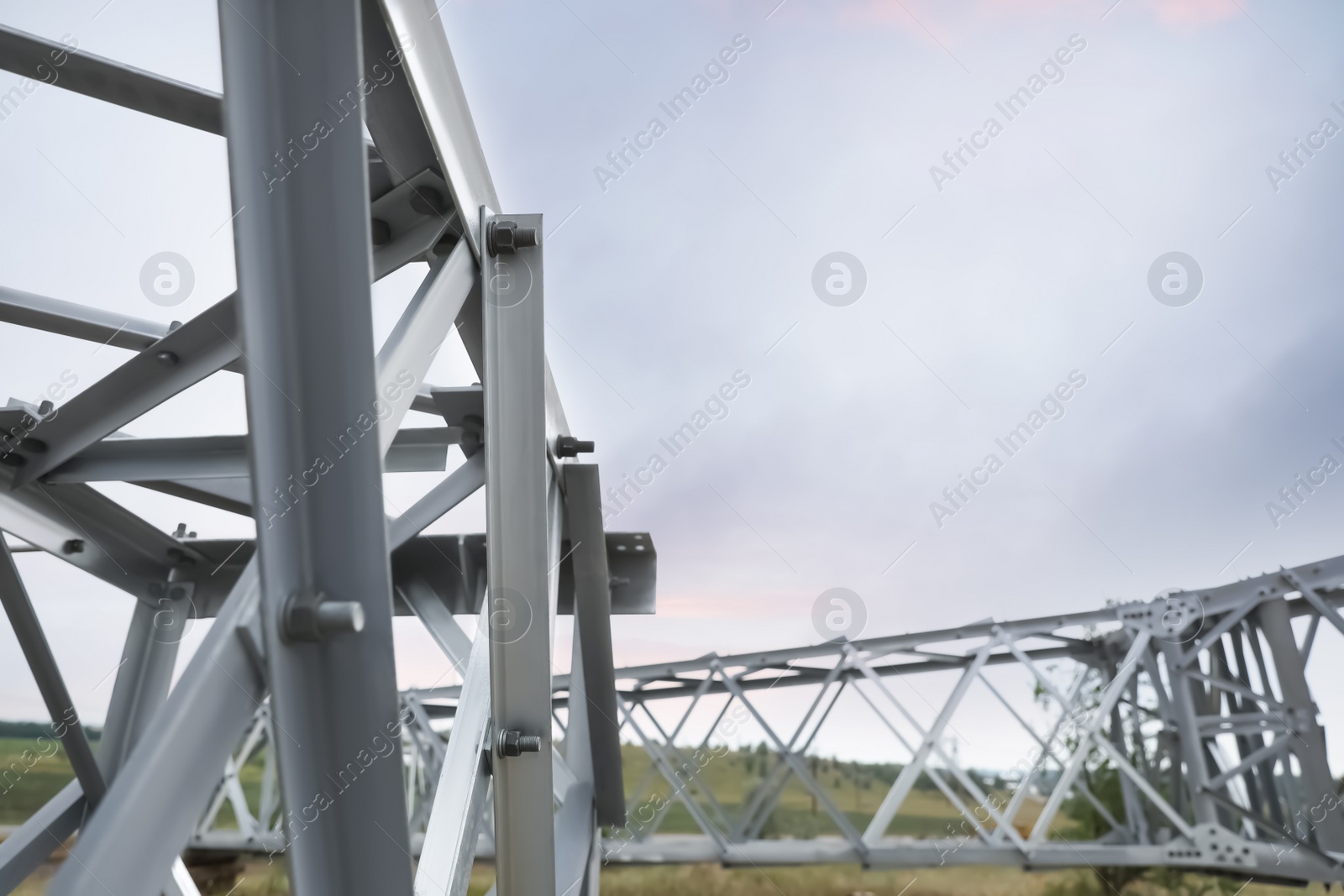 Photo of High voltage tower construction outdoors, closeup. Installation of electrical substation