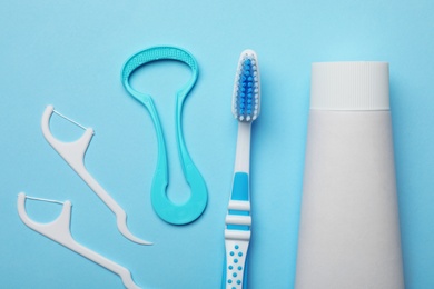 Photo of Flat lay composition with tongue cleaner and teeth care products on color background