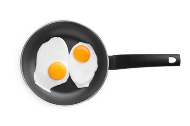 Tasty fried eggs in pan isolated on white, top view