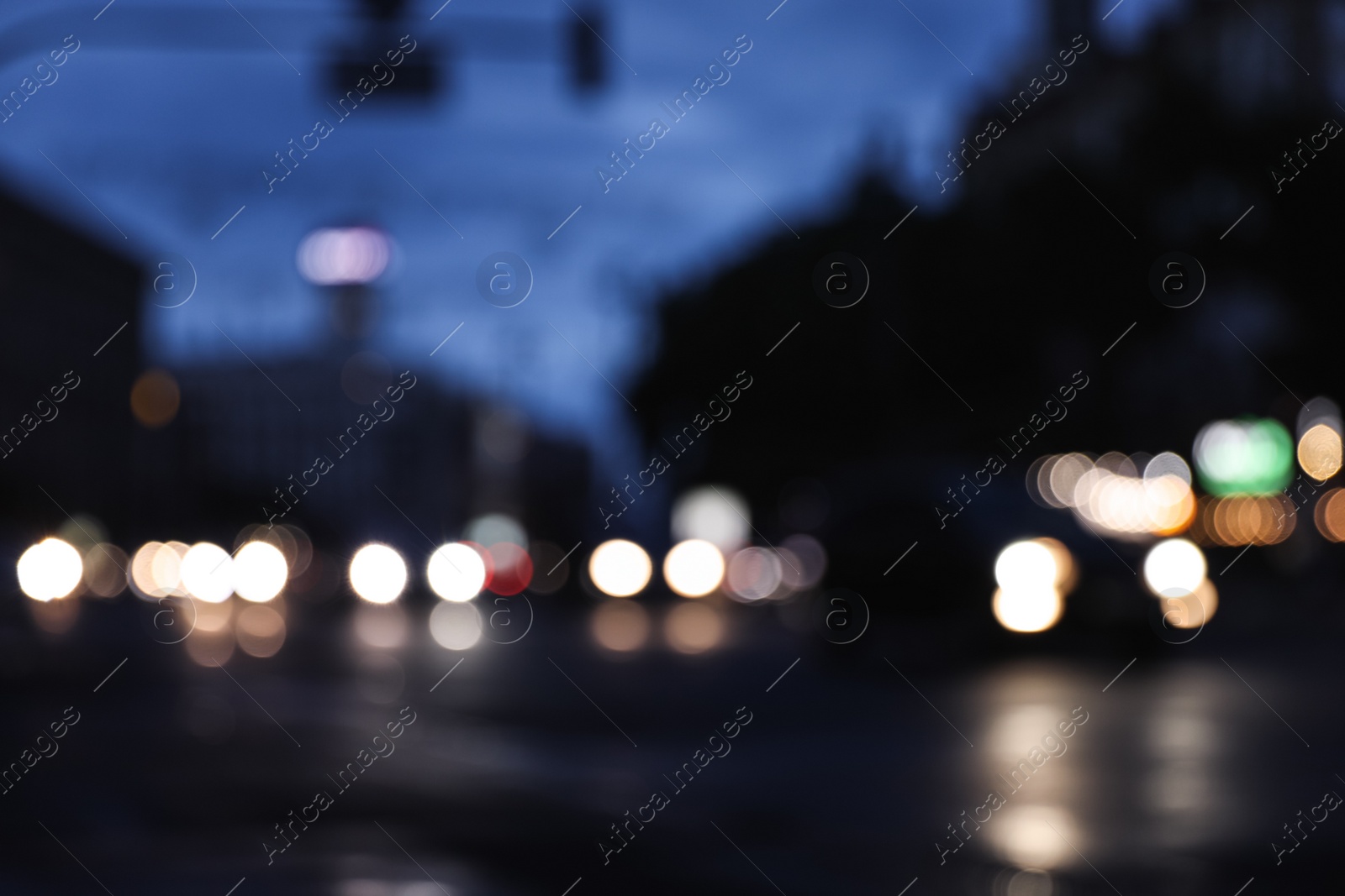 Photo of Blurred view of modern city at evening. Bokeh effect