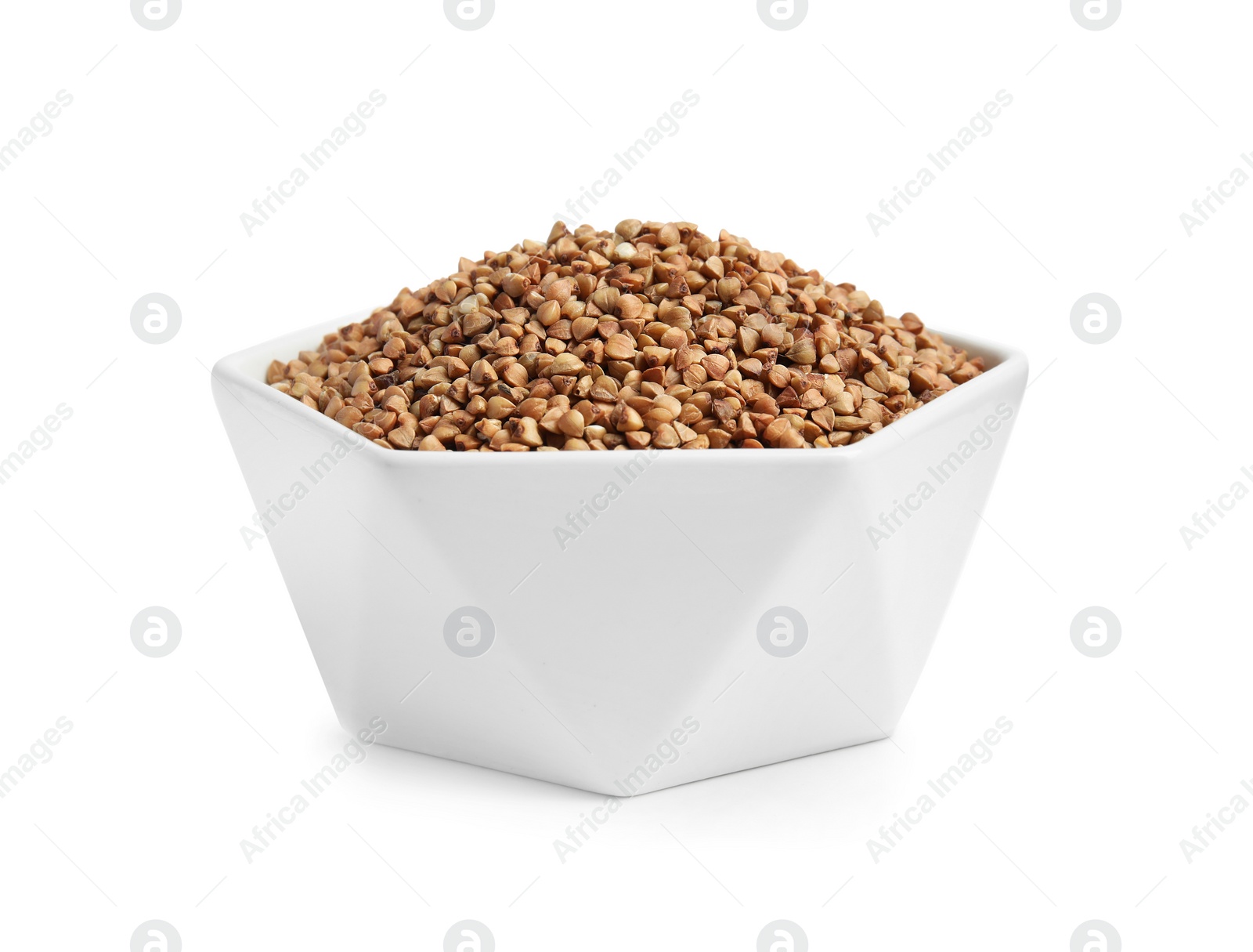 Photo of Bowl with uncooked buckwheat on white background