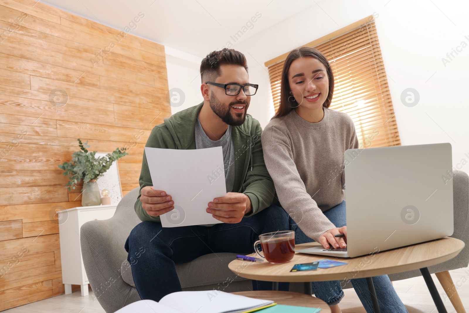 Photo of Young couple discussing family budget at home