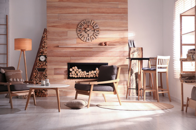 Decorative fireplace with stacked wood in cozy living room interior