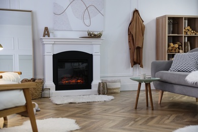 Photo of Beautiful living room interior with fireplace near white wall