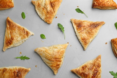 Photo of Flat lay composition with fresh delicious puff pastry on grey table