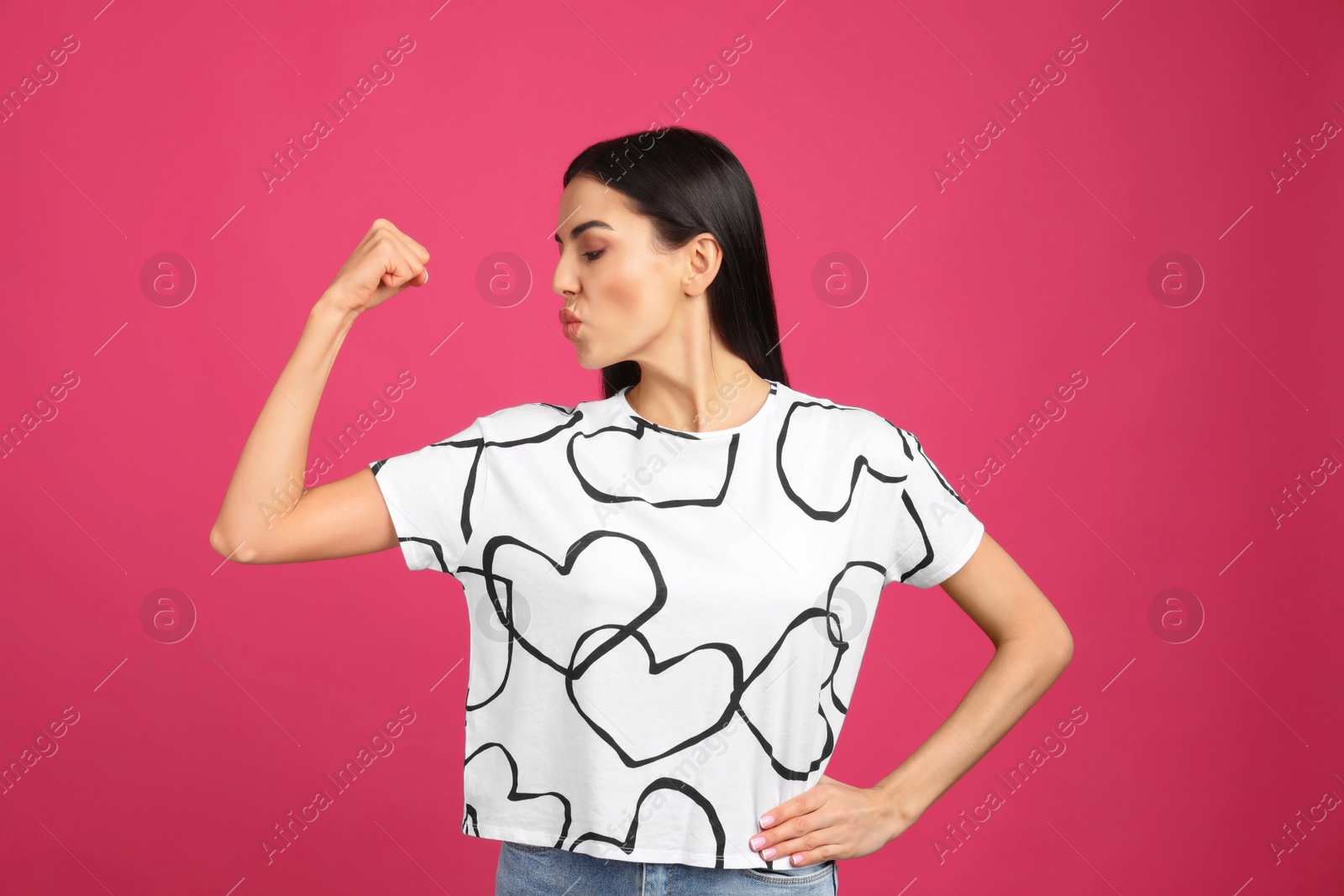 Photo of Strong woman as symbol of girl power on pink background. 8 March concept