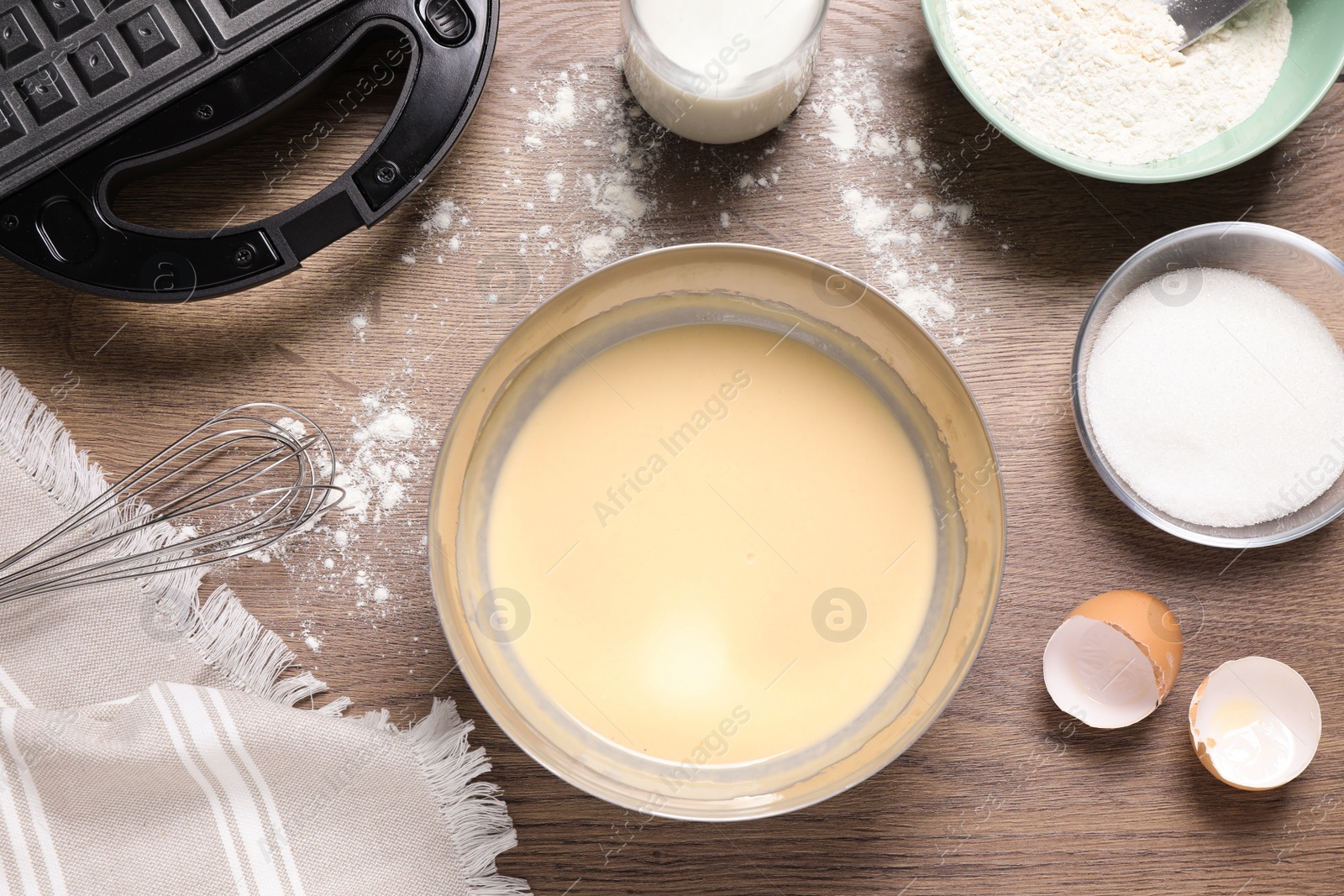 Photo of Flat lay composition with ingredients for cooking Belgian waffles on wooden table