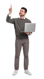 Photo of Handsome bearded businessman with laptop pointing at something on white background