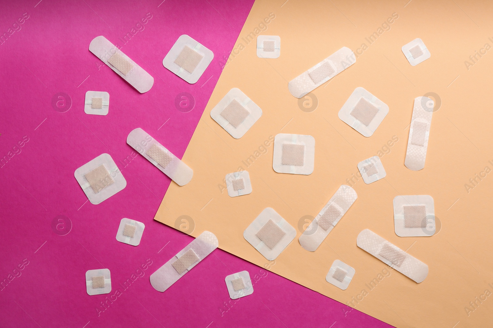 Photo of Different types of sticking plasters on color background, flat lay