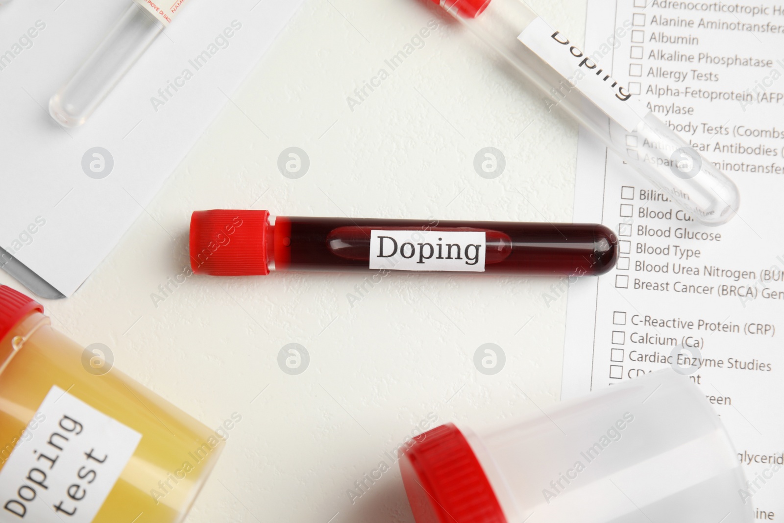 Photo of Test tubes and jars with samples on white table, above view. Doping control