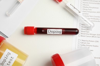 Test tubes and jars with samples on white table, above view. Doping control