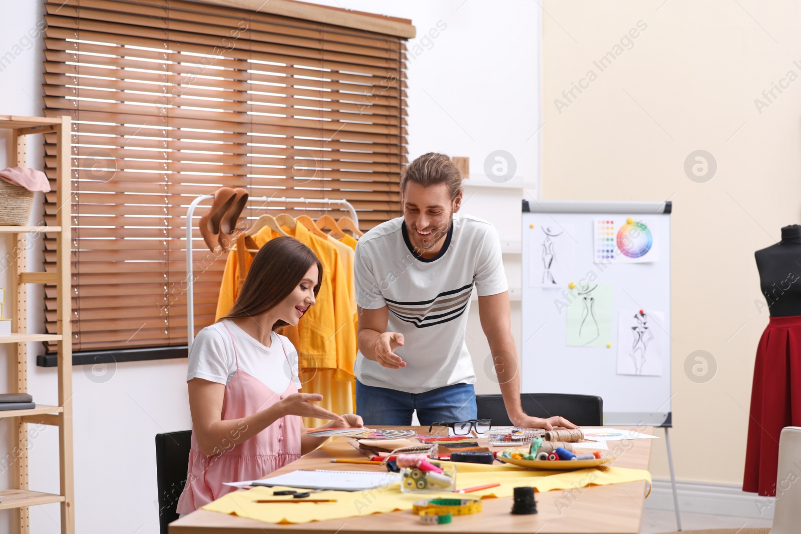 Photo of Fashion designers creating new clothes in studio