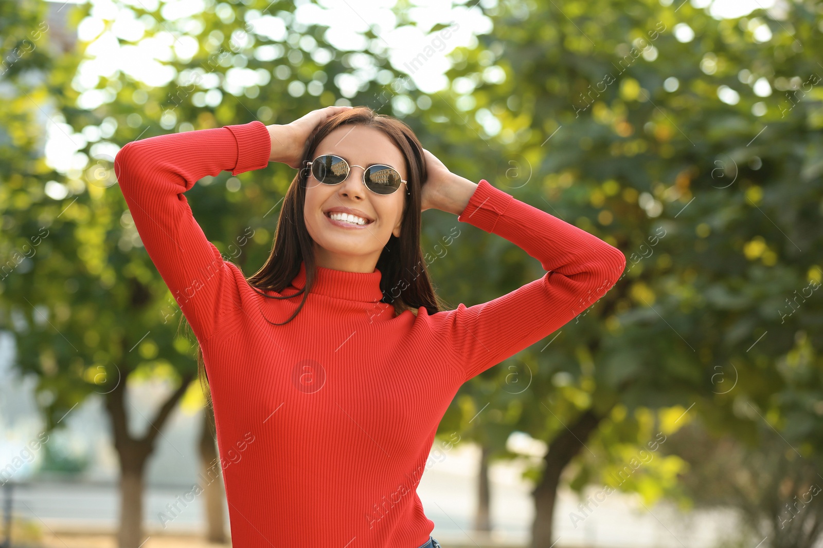 Photo of Beautiful woman wearing stylish sunglasses in green park