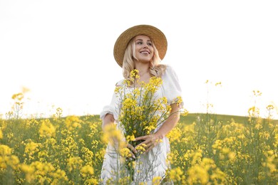 Portrait of happy young woman in field on spring day