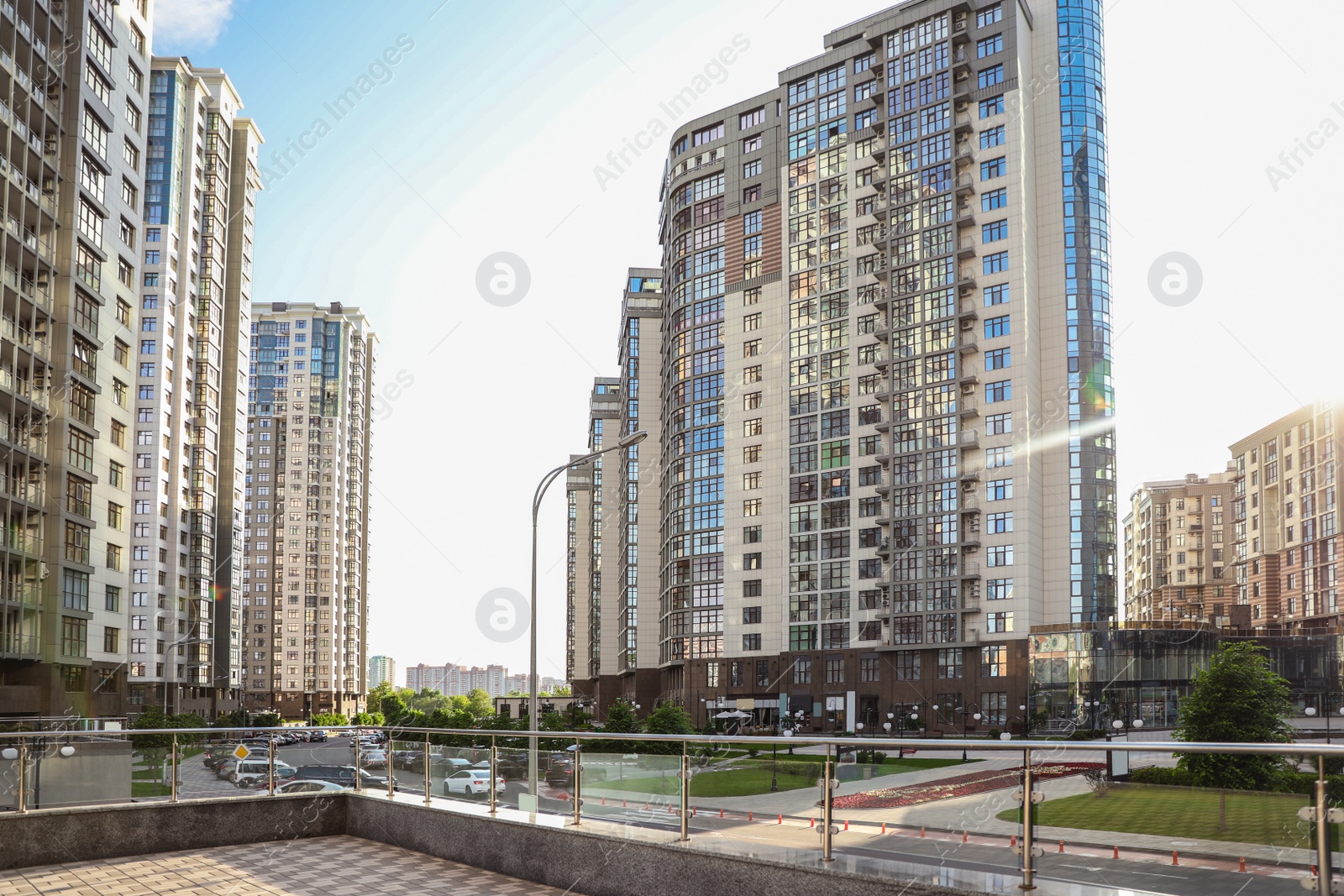 Photo of Modern buildings with tinted windows against sky. Urban architecture