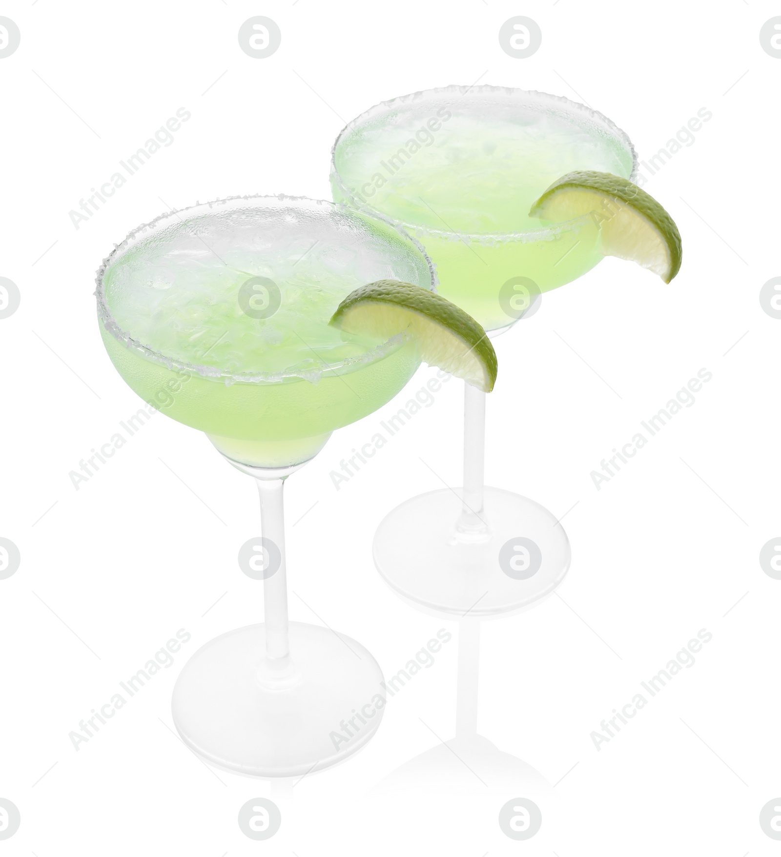 Photo of Delicious Margarita cocktail with ice cubes in glasses, salt and lime isolated on white