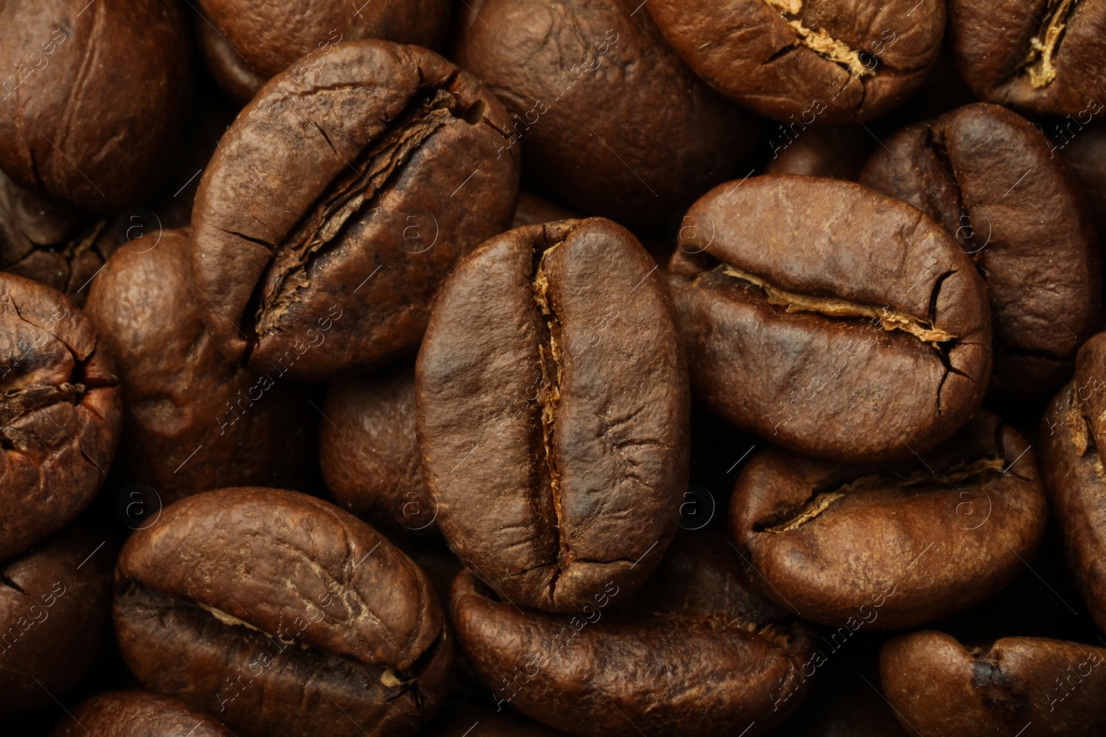 Photo of Pile of roasted coffee beans as background, closeup