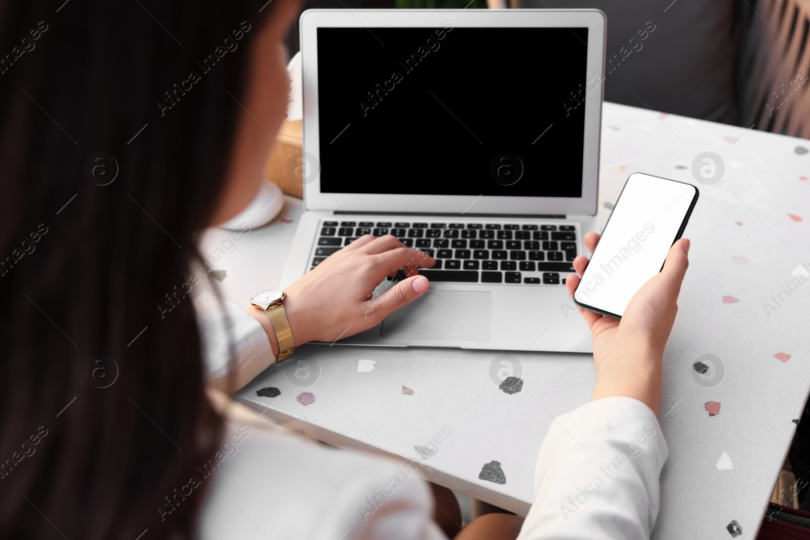 Photo of Woman using smartphone at table in cafe, closeup