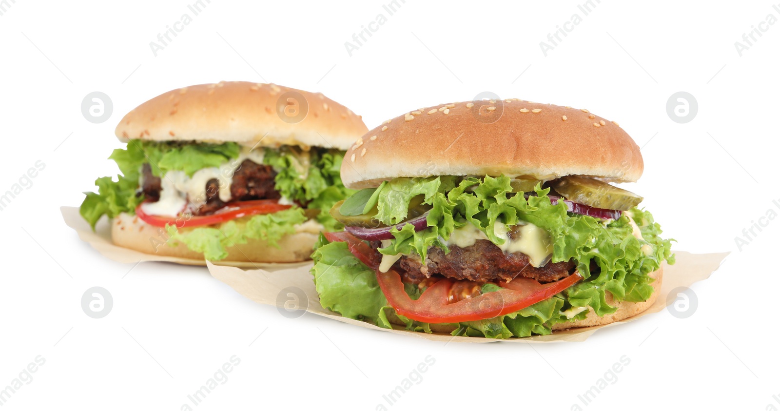 Photo of Delicious burgers with beef patty and lettuce isolated on white