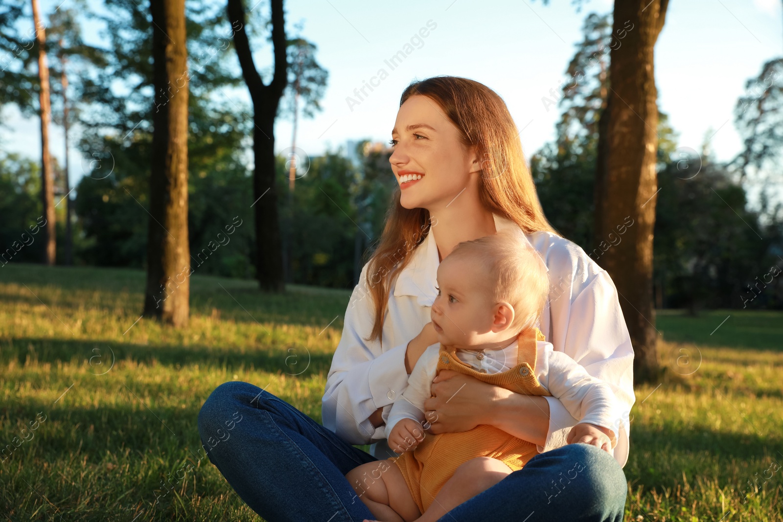 Photo of Beautiful mother with her cute daughter spending time together in park on summer day