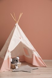 Cute child room interior with play tent near pink wall