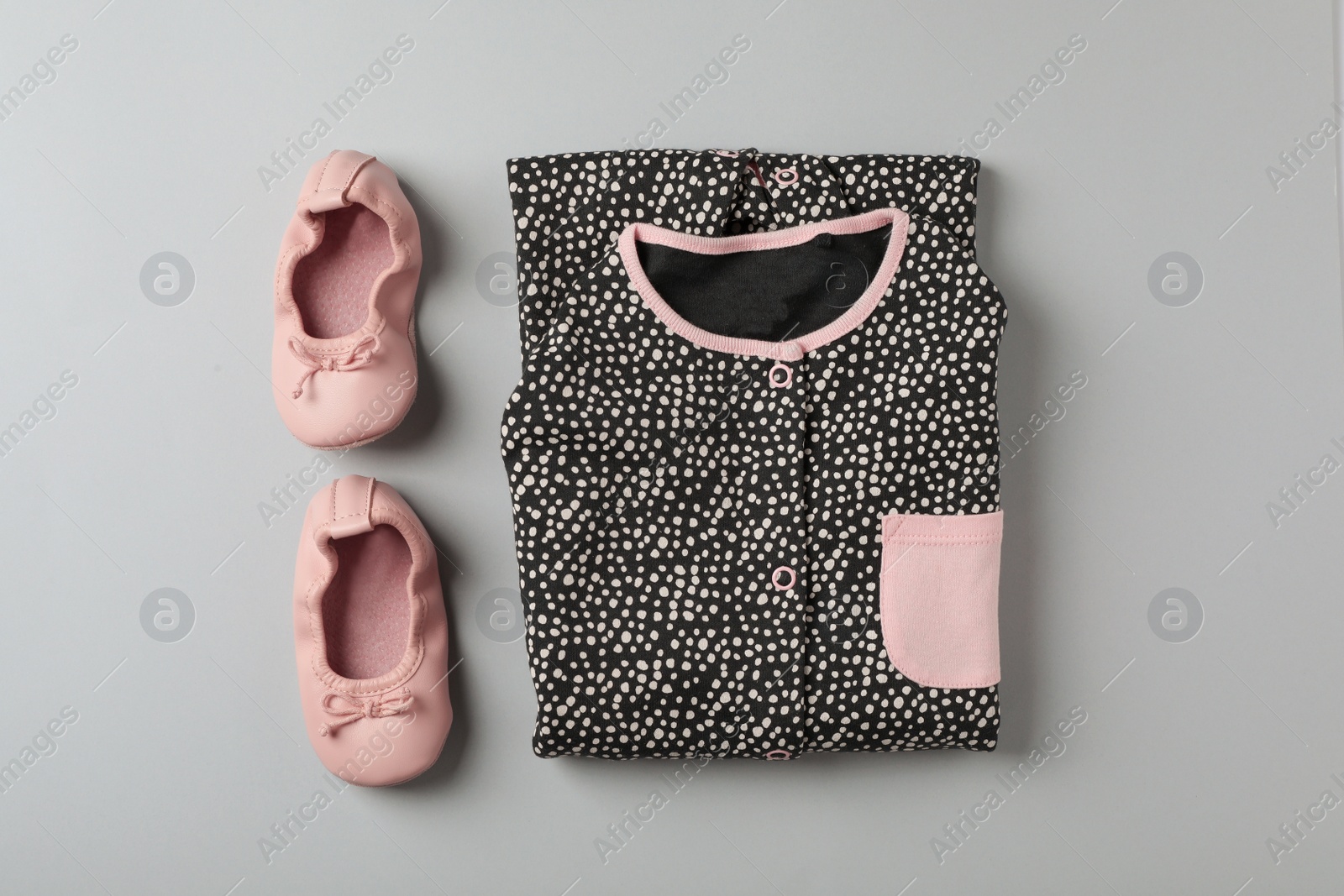 Photo of Flat lay composition with cute child clothes and shoes on color background