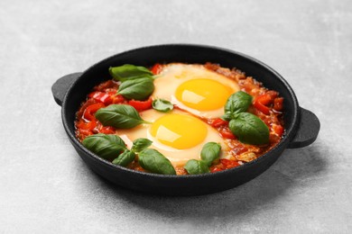 Photo of Delicious Shakshuka on light grey table, closeup